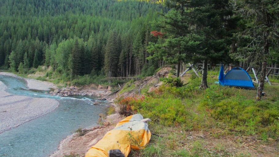 Backpacking site with two tents on a bluff overlooking the river in Montana.