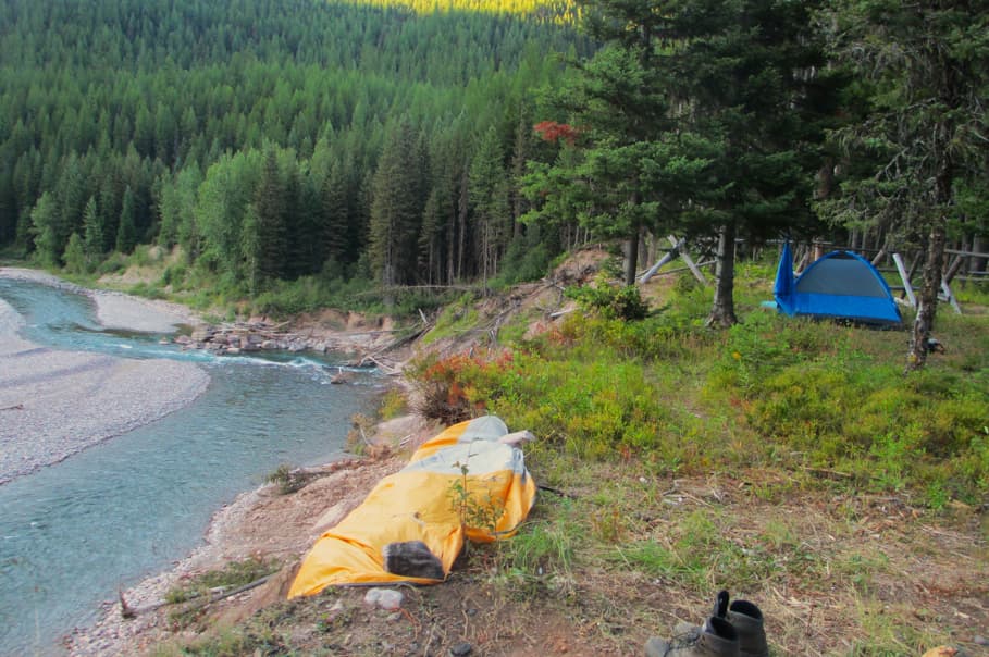 Backpacking site with two tents on a bluff overlooking the river in Montana.