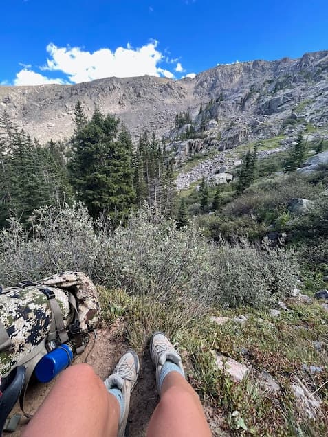 Hiker sitting at a viewpoint on a backpacking trip.