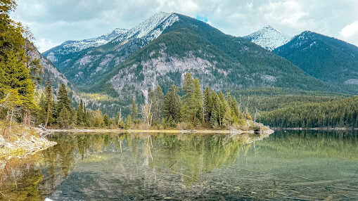 Reflection of mountains on Holland Lake in northwest Montana.