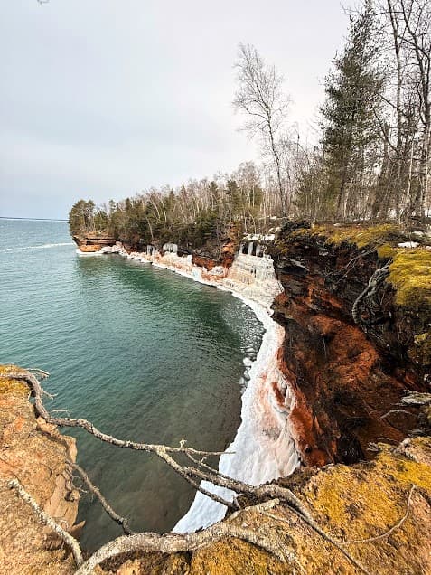 View of the Bowl at the Apostle Islands sea caves. Red sandstone cliffs and ice plunging into Lake Superior, Wisconsin.