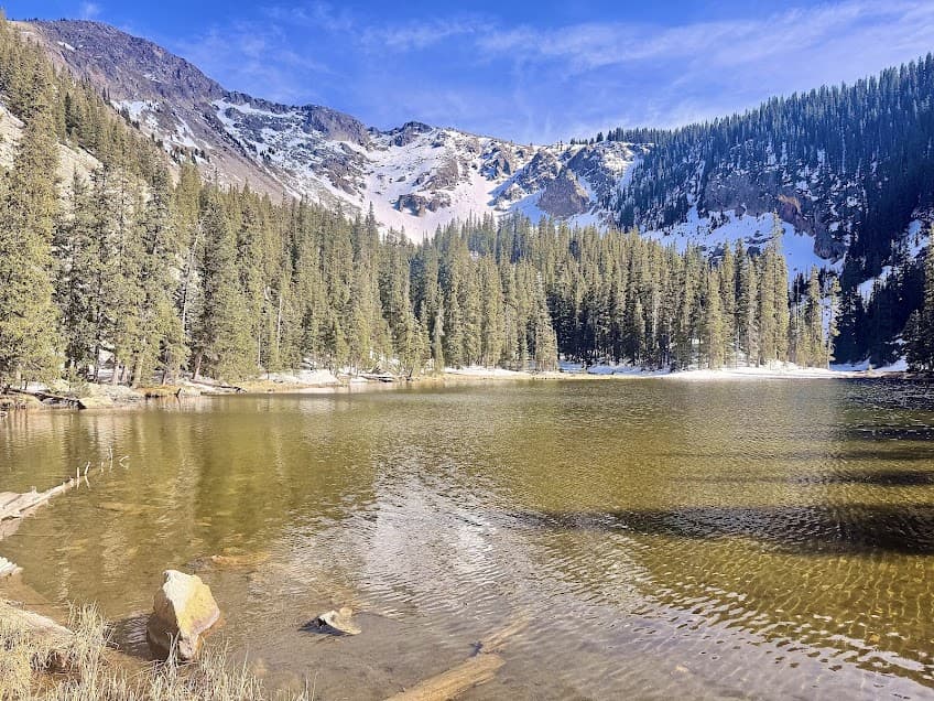 Alpine lake in northern New Mexico- Nambe Lake surrounded by mountains. 