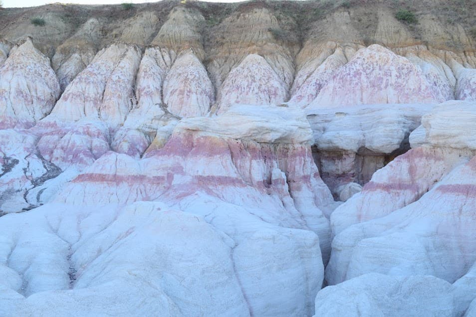 Pink and orange sedimentary rock formations at the Paint Mines Interpretive Site in Colorado.