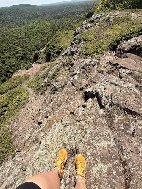 Trail running shoes on a rocky trail while training for an ultramarathon.