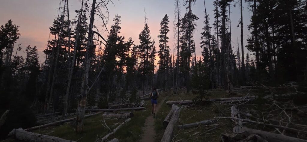 Runner completing an ultramarathon at sunset.