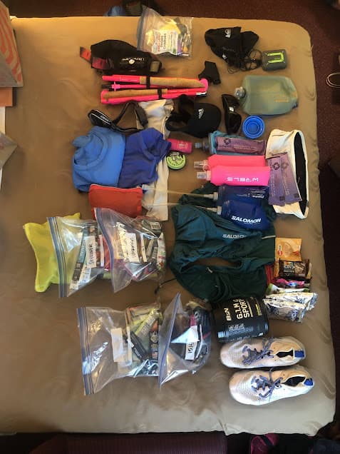 Spread of ultrarunning gear for a trail race.